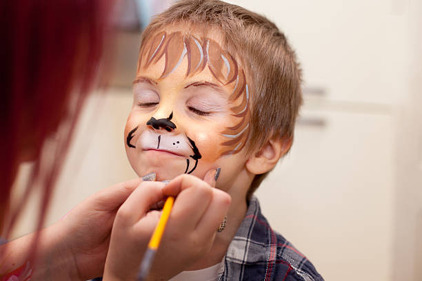 Little boy with painted face as a lion